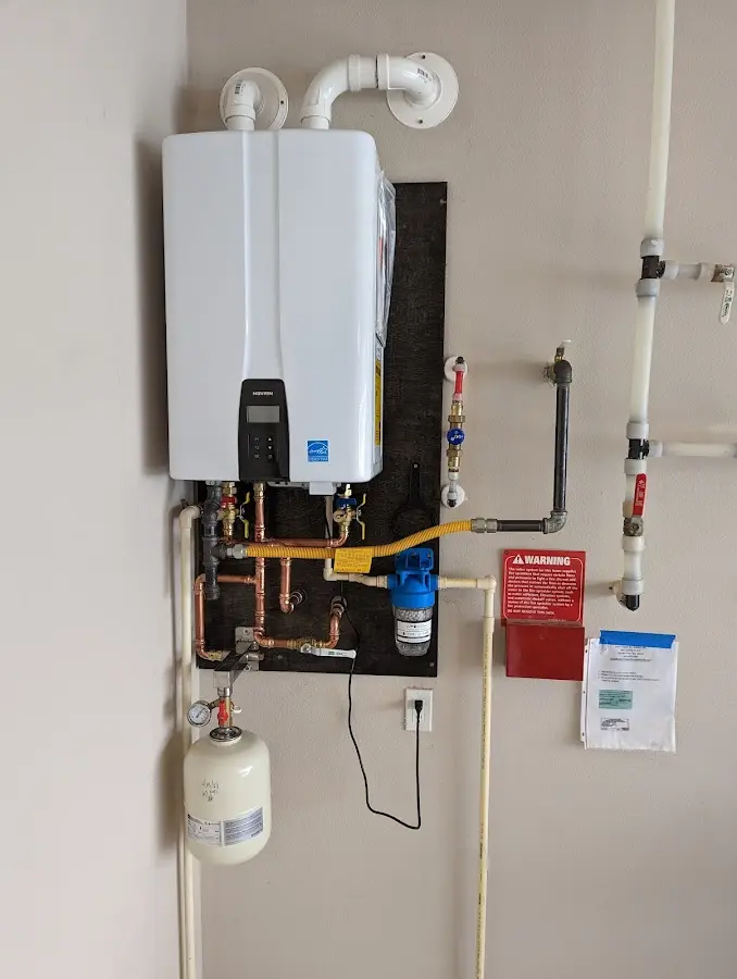 Professional plumber installing copper piping in a Epping home